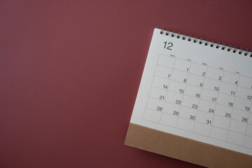 close up of calendar on the crimson table background, planning for business meeting or travel planning concept