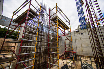 Fototapeta premium Construction site workers and crane, Many workers were building under construction building with advanced equipment and cranes.