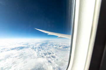 View out of a Boeing 787 window while flying over snow-covered mountains. 