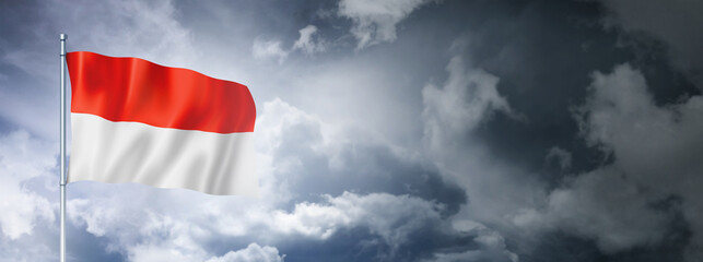 Monaco flag on a cloudy sky