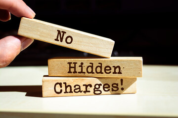 Businessman puts wooden blocks with No Hidden Charges.