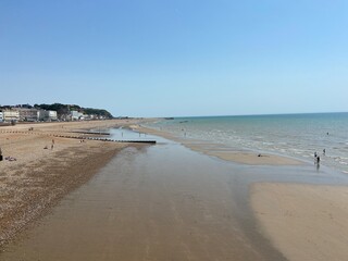 Hastings, East Sussex, UK - popular summer Hastings beach, waves hitting beach groynes, beach in St Leonards, Hastings, East Sussex south coast UK
