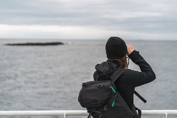 Female photographer on ship deck