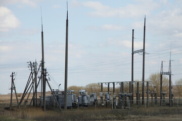 Rural electric plant transformer and pilons on the field