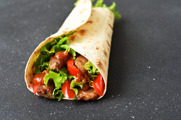 Lavash appetizer with lettuce, meat and sauce. Shawarma. Mexican tacos.