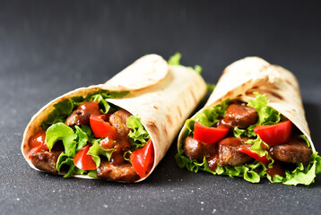 Lavash appetizer with lettuce, meat and sauce. Shawarma. Mexican tacos.