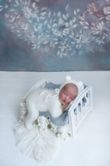 Beautiful newborn baby sleeps with knitted toys