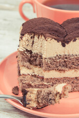 Creamy tiramisu cake with different layers and black coffee. Delicious dessert for celebrations