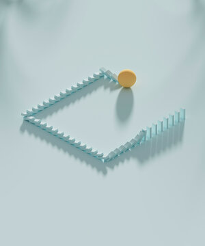 Studio shot of yellow sphere knocking down domino pieces organized in square shape