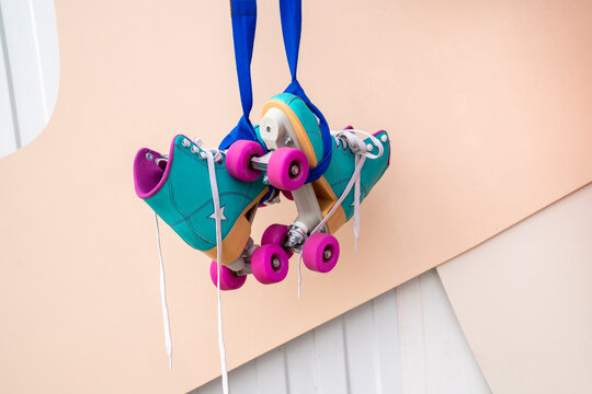 Roller skates hanging in front of wall