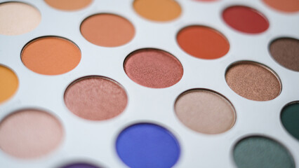 Selective focus of eyeshadow palette with various colors in pearly and matte closeup