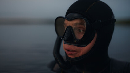 Scuba diver looking away while submerged in sea water