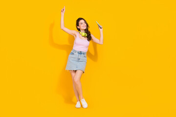 Fototapeta na wymiar Full length photo of shiny dreamy woman wear pink top enjoying good song dancing isolated yellow color background