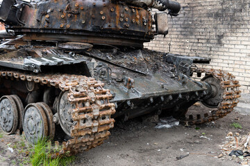 Fototapeta na wymiar A close-up of a destroyed Russian tank during the military invasion of Ukraine. Ukraine war