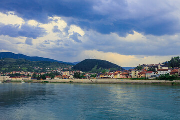 Naklejka na ściany i meble Panoramic View in the Rainy Day to the Višegrad with the Rainbow over the Drina River, Bosnia and Herzegovina