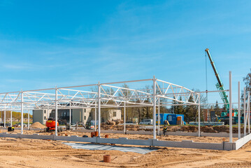 Urban area with machinery, people are working on construction site.