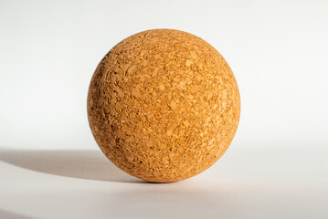 Nice brown cork ball lie on the white gray background,close up.