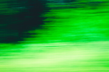 Abstract Green trees motion blurred green leaves background.