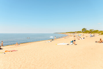 Fototapeta na wymiar Crowded beach in summer hot bright summer day.
