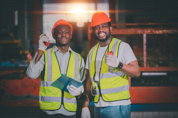 Teamwork African American black man are worker and working in metal heavy factory