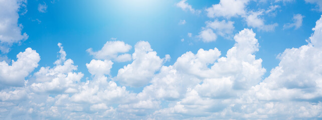 Naklejka na ściany i meble Abstract white puffy clouds and blue sky background.