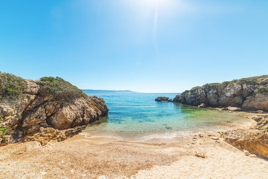 Rocks and sand under a shining sun in Sardinia