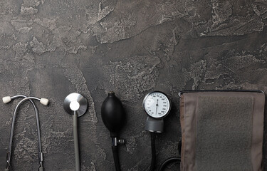 Gray tonometer on a black marble background. Medical equipment blood pressure monitor. Healthcare. Place for text. Medicine concept. The concept of cardiology.