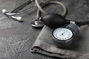 Gray tonometer on a black marble background. Medical equipment blood pressure monitor. Healthcare....