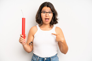 hispanic pretty girl looking shocked and surprised with mouth wide open, pointing to self. dynamite concept