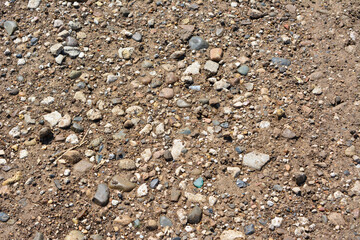 pebbles on dirty country road, close-up
