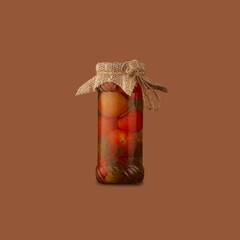 Glass jar with canned tomatoes is isolated on a brown background.