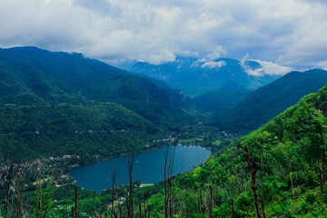 Fototapeta na wymiar Panoramic View to the Blue Mountain Lake among the Green Forest Trees in the heart of Bosnia and Herzegovina