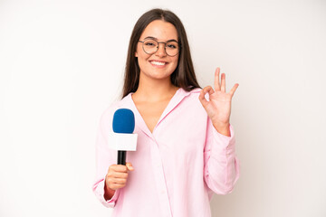 hispanic pretty woma making capice or money gesture, telling you to pay. journalist with a...
