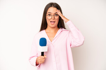 hispanic pretty woma looking angry, annoyed and frustrated. journalist with a microphone