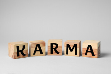 Word Karma made of cubes with letters on light background