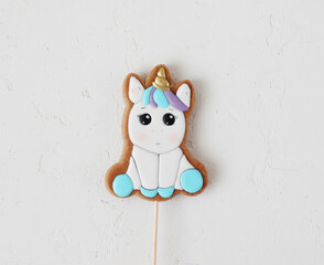 Homemade gingerbread cookies with icing, hand-painted in the form unicorn. Selective focus.