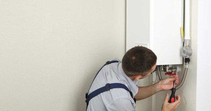 A plumber is attempting to fix a residential heating problem.