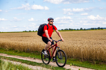 Obraz premium bike adventure travel photo. bike tourist rides on the country road