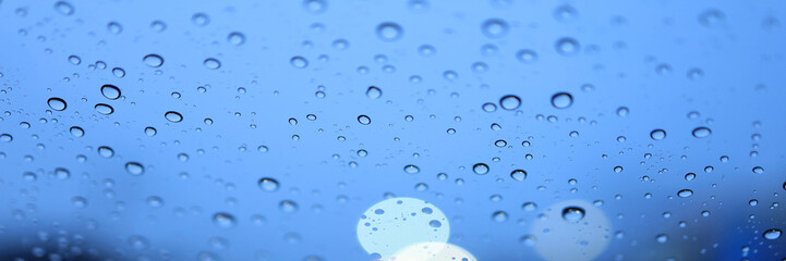Banner rain drop in win sheild glass and bokeh light.