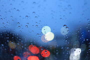 Rain drop in win sheild glass and bokeh light.