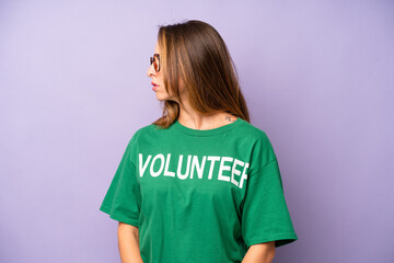 pretty caucasian woman on profile view thinking, imagining or daydreaming. volunteer concept