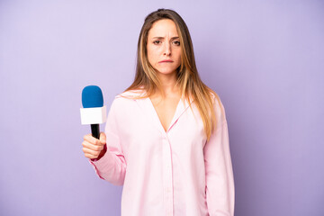 pretty caucasian woman looking puzzled and confused. journalist and microphone concept