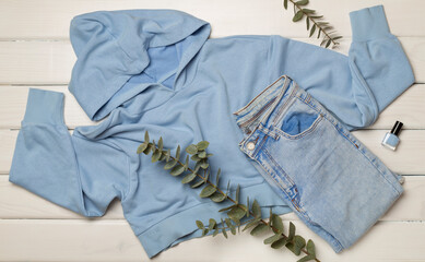 Flat Lay with women casual outfit on wooden background, top view