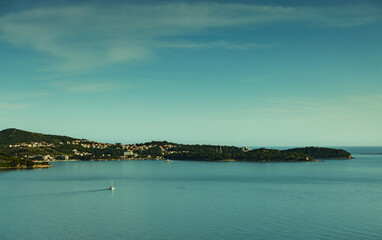 Sea landscape, Adriatic Sea, islands visible on the horizon, view of the bay and the town of Cavtat, sunny day, the sky partly covered with clouds.
