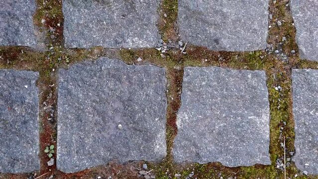 Old bricklaying close up. Granite texture. Old paving stones. Paving tiles.
