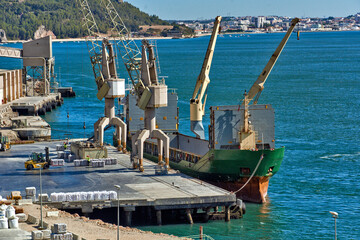 crane loading a cargo ship on a quay in Setubal, Portugal