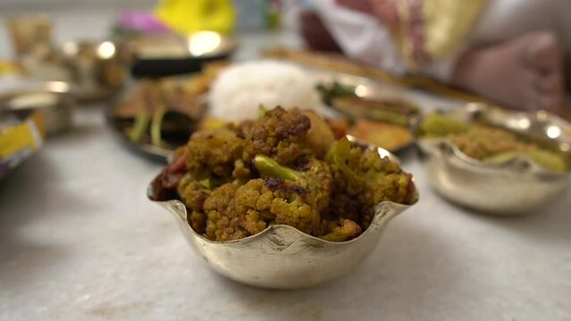 Video of phool gobi  masala along with other dishes in Annaprashan rituals or Mukhe bhaat in Kolkata, India.