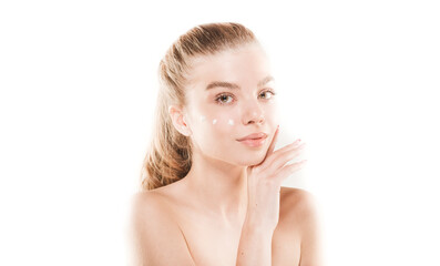 Posing and putting some cream on her face in studio on white background. Skin care. Spa