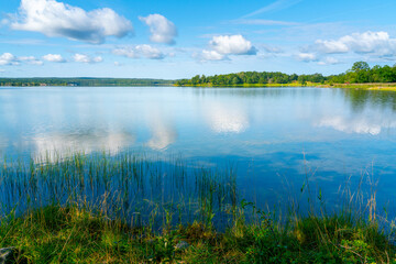 Beautiful summer day in Swedish landscape of Segersgarde nature reservation. Green forests, meadows view from the top of the rock. Summer holiday in Sweden. Brackish waters of gulf of Bothnia. © Petr