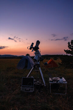 Astronomical telescope and camera equipment for capturing, observing stars, Milky way and planets in nature, far from light pollution and urban zones.